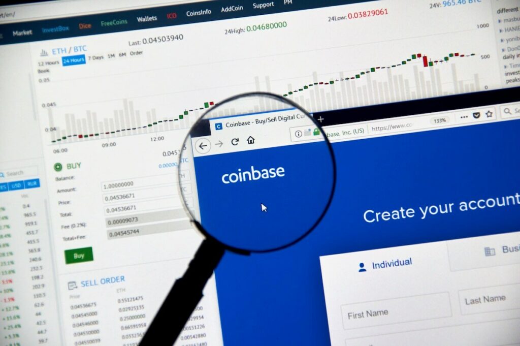 A magnifying glass over the Coinbase website