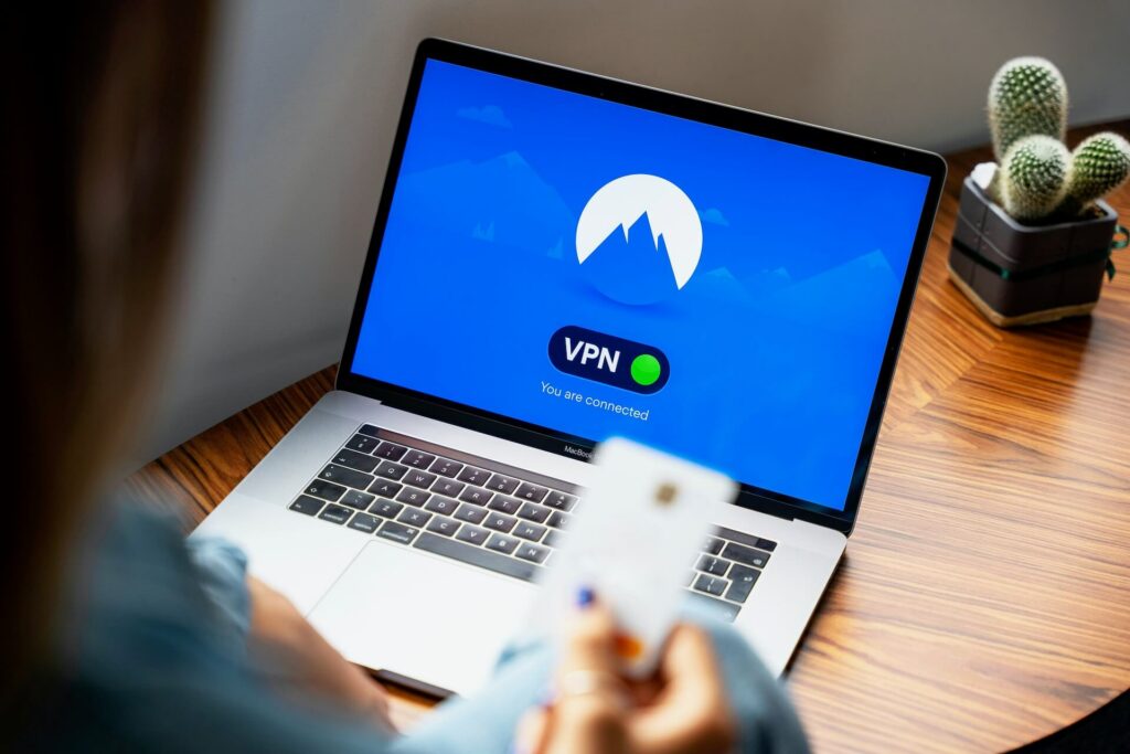 A woman using a VPN on a MacBook