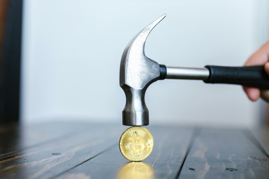 A hammer hitting bitcoin
