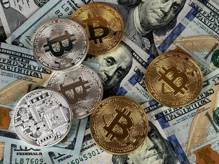 Bitcoins on top of US dollar bills