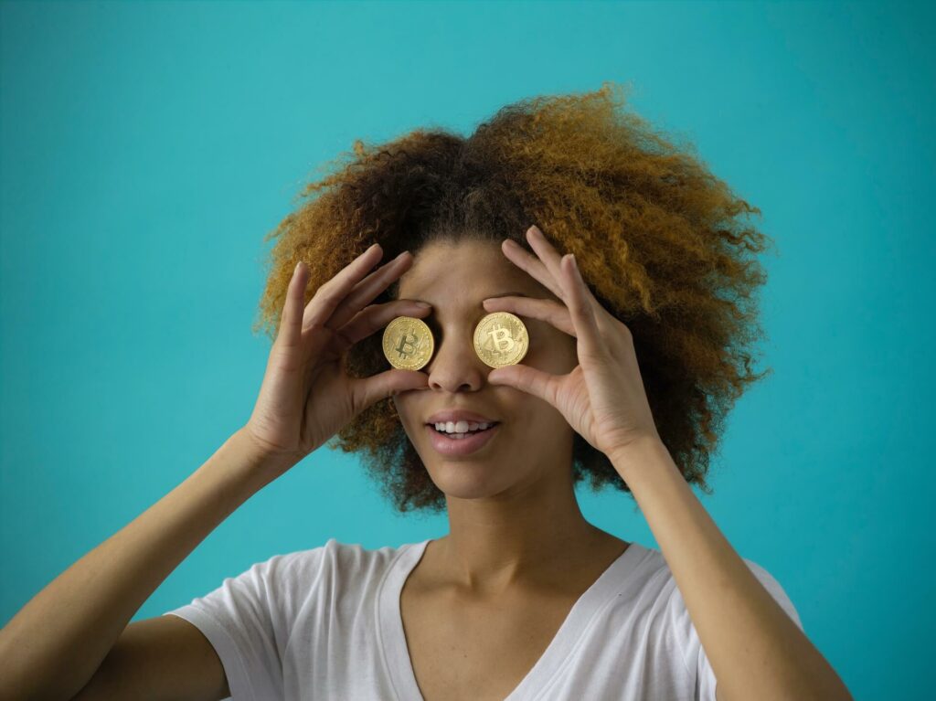 Girl holding two coins on her eyes
